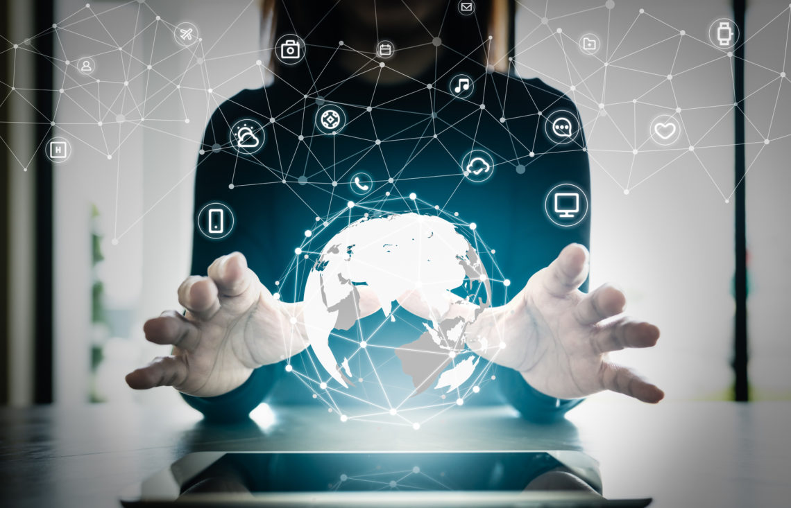 Close up hand's woman over digital planet global connection with communication network application icon,  internet of things (IoT) and Digital era. Marketing 4.0