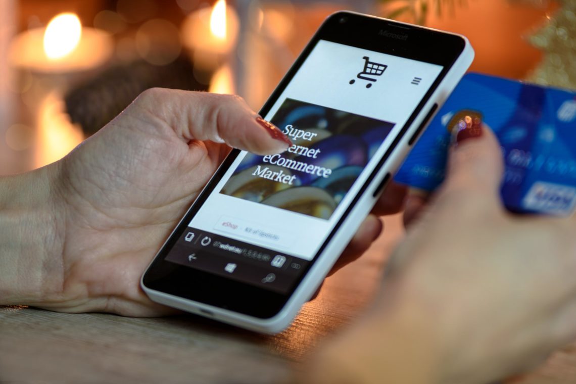 Photo by PhotoMIX Company from Pexels: https://www.pexels.com/photo/person-using-black-and-white-smartphone-and-holding-blue-card-230544/