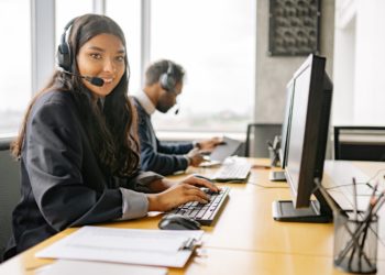 Photo by Yan Krukau from Pexels: https://www.pexels.com/photo/a-smiling-woman-working-in-a-call-center-while-looking-at-camera-8867434/