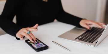 Photo by Karolina Grabowska: https://www.pexels.com/photo/crop-woman-using-smartphone-and-laptop-during-work-in-office-4467737/
