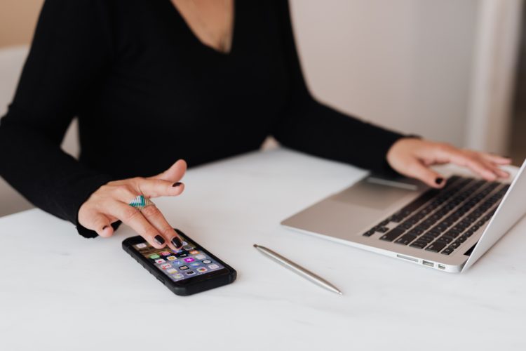 Photo by Karolina Grabowska: https://www.pexels.com/photo/crop-woman-using-smartphone-and-laptop-during-work-in-office-4467737/