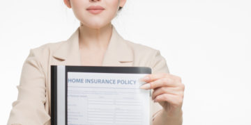 Photo by Mikhail Nilov from Pexels: https://www.pexels.com/photo/woman-in-corporate-attire-holding-a-home-insurance-policy-7736070/