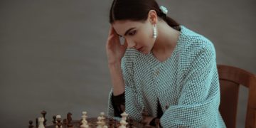Photo by emre keshavarz from Pexels: https://www.pexels.com/photo/pensive-ethnic-woman-thinking-on-chess-move-7207270/