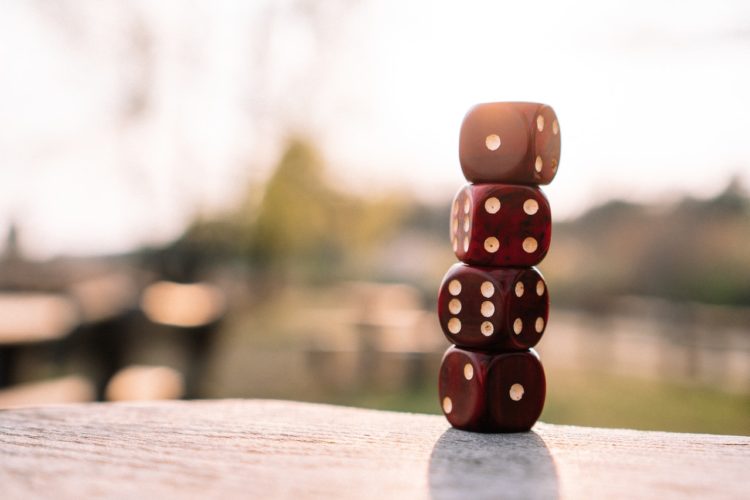 Photo by Matthias Groeneveld: https://www.pexels.com/photo/red-dice-stacked-on-table-on-terrace-4200740/