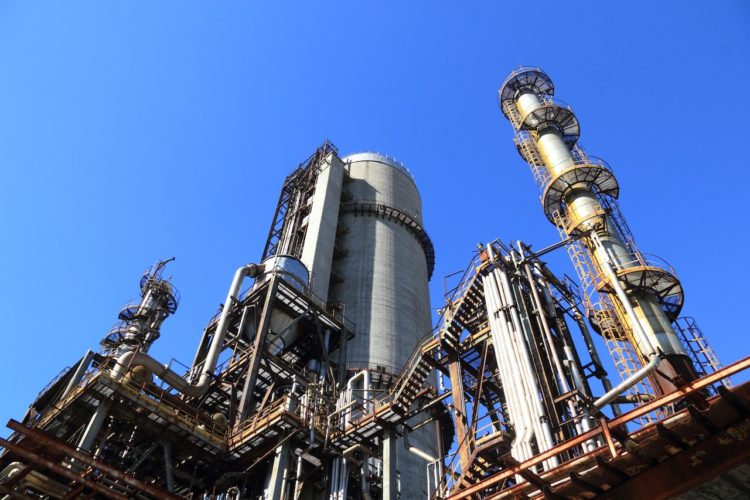 Photo by Pixabay: https://www.pexels.com/photo/low-angle-shot-of-manufacturing-plant-under-blue-sky-257700/