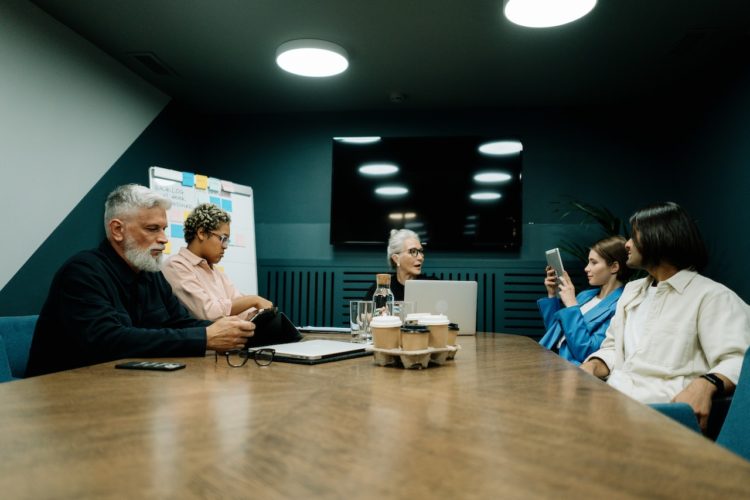 Photo by cottonbro studio: https://www.pexels.com/photo/elderly-woman-talking-to-employees-at-the-meeting-5990264/