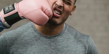 Photo by Julia Larson : https://www.pexels.com/photo/unrecognizable-boxer-hitting-young-ethnic-sportsman-during-training-6456268/