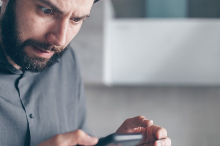 Photo by Mikhail Nilov: https://www.pexels.com/photo/man-in-gray-shirt-looking-at-a-smartphone-7534386/