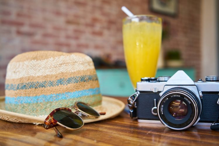 Photo by Pixabay: https://www.pexels.com/photo/gray-and-black-dslr-camera-beside-sun-hat-and-sunglasses-413960/