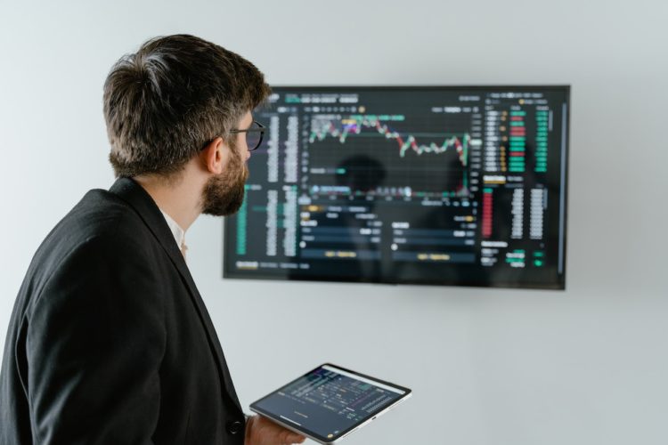 Photo by Tima Miroshnichenko: https://www.pexels.com/photo/man-in-black-suit-holding-a-digital-tablet-and-looking-at-data-on-screen-7567595/