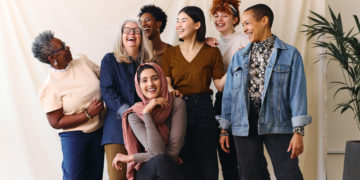 Portrait of cheerful mixed age range multi ethnic women celebrating International Women's Day