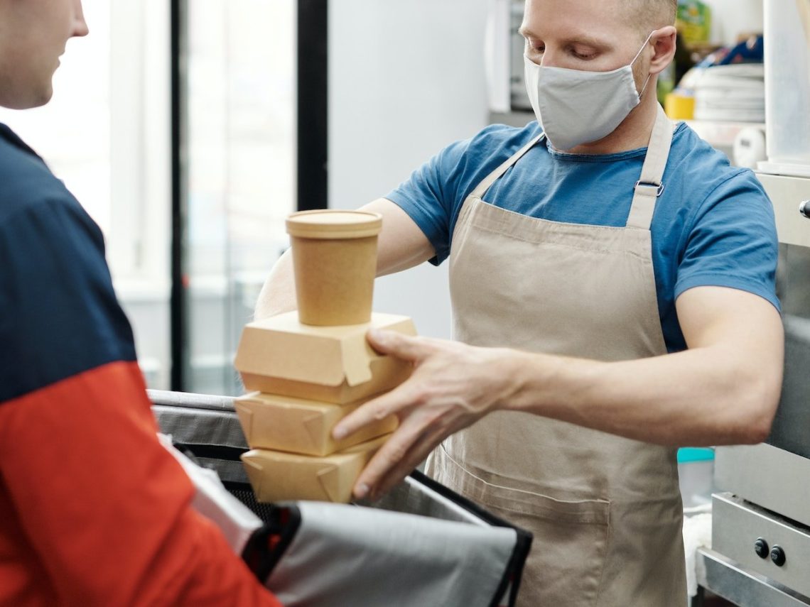 Photo by Norma Mortenson: https://www.pexels.com/photo/man-wearing-a-face-mask-putting-food-on-a-thermal-bag-4393667/