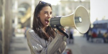 Photo by Andrea Piacquadio: https://www.pexels.com/photo/cheerful-young-woman-screaming-into-megaphone-3761509/