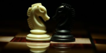 Photo by Syed Hasan Mehdi: https://www.pexels.com/photo/two-white-and-black-chess-knights-facing-each-other-on-chess-board-839428/