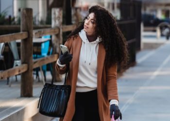 Photo by Tim Douglas : https://www.pexels.com/photo/attentive-female-carrying-shopping-bags-while-walking-with-smartphone-6567663/