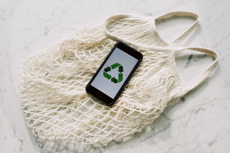 Photo by ready made: https://www.pexels.com/photo/mobile-phone-with-green-recycling-sign-and-mesh-bag-3850512/