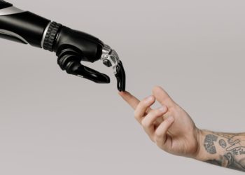 Photo by cottonbro studio: https://www.pexels.com/photo/bionic-hand-and-human-hand-finger-pointing-6153354/