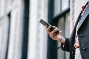 Photo by Ono Kosuki: https://www.pexels.com/photo/crop-businesswoman-messaging-on-smartphone-while-standing-near-building-on-street-5999786/