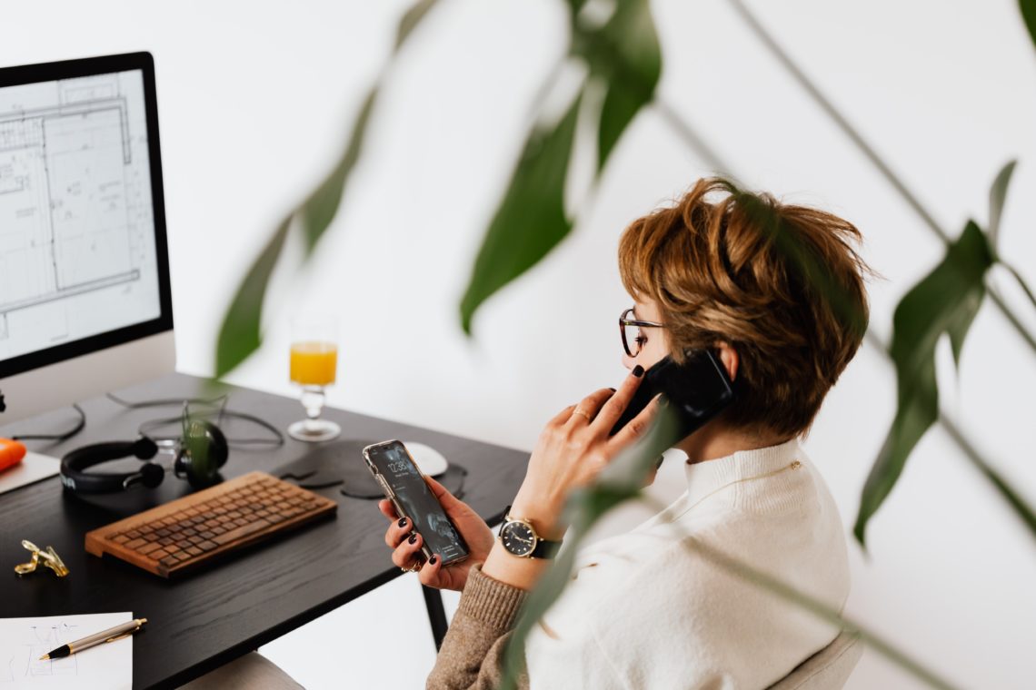 Photo by Karolina Grabowska: https://www.pexels.com/photo/busy-female-talking-on-smartphone-and-checking-messages-during-work-in-contemporary-office-4476635/