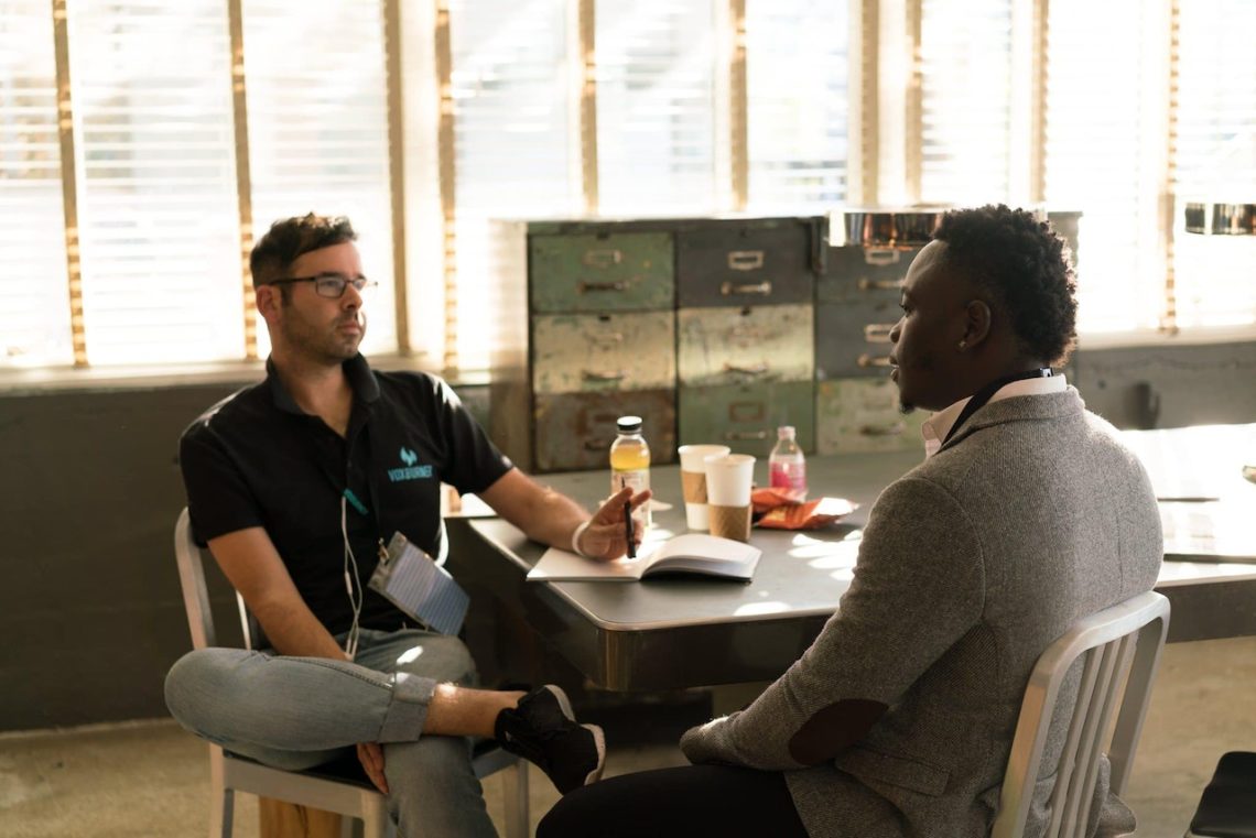 Photo by nappy: https://www.pexels.com/photo/man-wearing-black-polo-shirt-and-gray-pants-sitting-on-white-chair-935977/