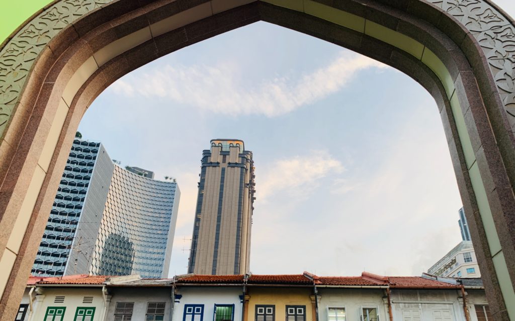 Photo by Shamsuddin Habib: https://www.pexels.com/photo/parkview-square-skyscraper-seen-through-gate-against-blue-sky-in-singapore-18249195/
