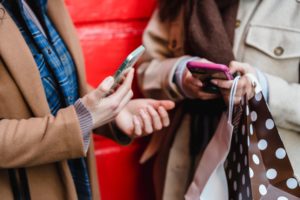 Photo by Tim Douglas : https://www.pexels.com/photo/unrecognizable-women-messaging-on-smartphones-after-shopping-in-city-6567382/