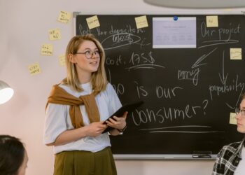 Photo by Tima Miroshnichenko from Pexels: https://www.pexels.com/photo/a-woman-in-white-shirt-standing-near-the-chalkboard-6914632/