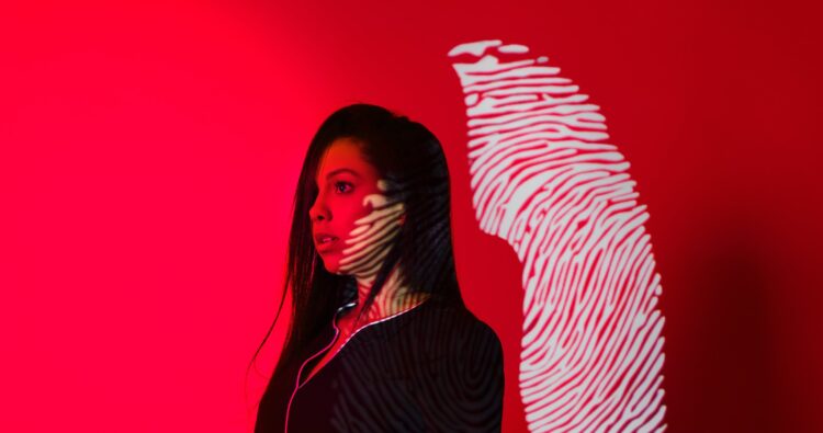 Photo by Cleyton Ewerton: https://www.pexels.com/photo/woman-with-fingerprint-reflection-on-red-background-5063551/