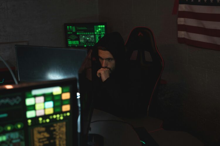 Photo by Tima Miroshnichenko: https://www.pexels.com/photo/man-in-black-hoodie-sitting-on-chair-looking-at-computer-monitor-5380585/