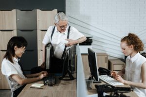 Photo by Ron Lach : https://www.pexels.com/photo/senior-man-talking-to-young-call-center-agents-8691842/