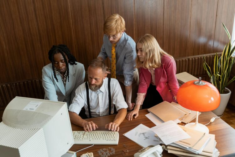 Photo by MART PRODUCTION: https://www.pexels.com/photo/team-of-businesspeople-looking-at-a-computer-monitor-8872390/