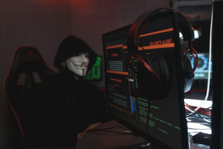 Photo by Tima Miroshnichenko: https://www.pexels.com/photo/person-in-black-hoodie-hacking-a-computer-system-5380651/