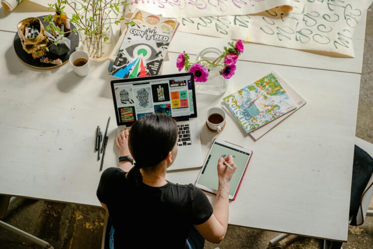 Photo by Antoni Shkraba: https://www.pexels.com/photo/photo-of-woman-writing-on-tablet-computer-while-using-laptop-4348401/