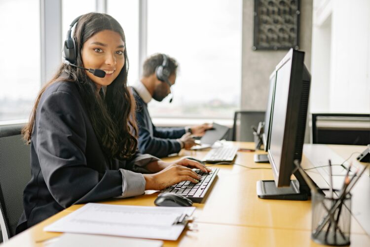 Photo by Yan Krukau: https://www.pexels.com/photo/a-smiling-woman-working-in-a-call-center-while-looking-at-camera-8867434/