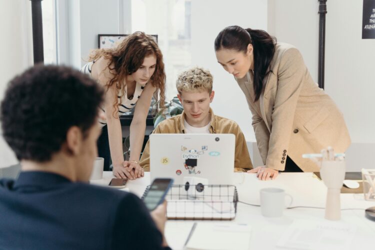 Photo by cottonbro studio: https://www.pexels.com/photo/women-standing-beside-a-man-using-a-laptop-7439129/