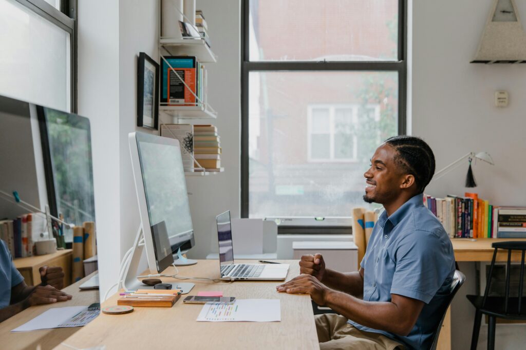 Photo by RDNE Stock project: https://www.pexels.com/photo/man-sitting-by-desk-using-computer-and-laptop-10376169/