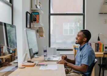 Photo by RDNE Stock project: https://www.pexels.com/photo/man-sitting-by-desk-using-computer-and-laptop-10376169/