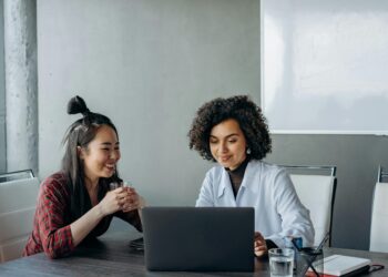 Photo by Mikhail Nilov: https://www.pexels.com/photo/women-having-a-conversation-while-looking-at-the-screen-of-a-laptop-8297687/