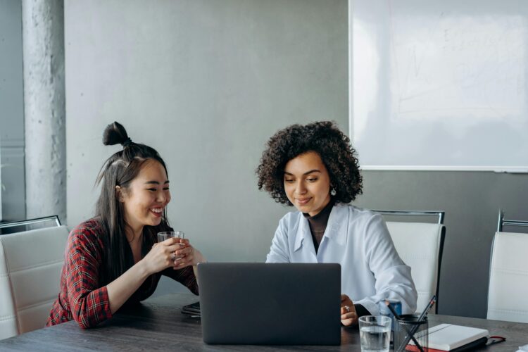 Photo by Mikhail Nilov: https://www.pexels.com/photo/women-having-a-conversation-while-looking-at-the-screen-of-a-laptop-8297687/