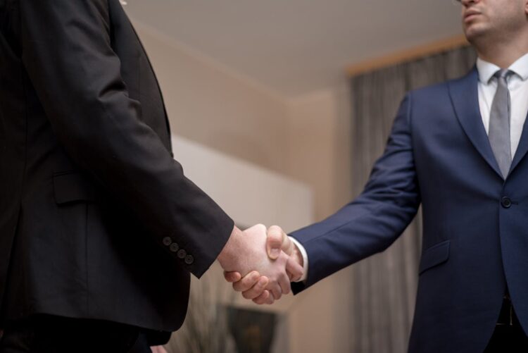 Photo by George Morina: https://www.pexels.com/photo/men-in-black-and-blue-suit-jacket-doing-handshake-6918507/