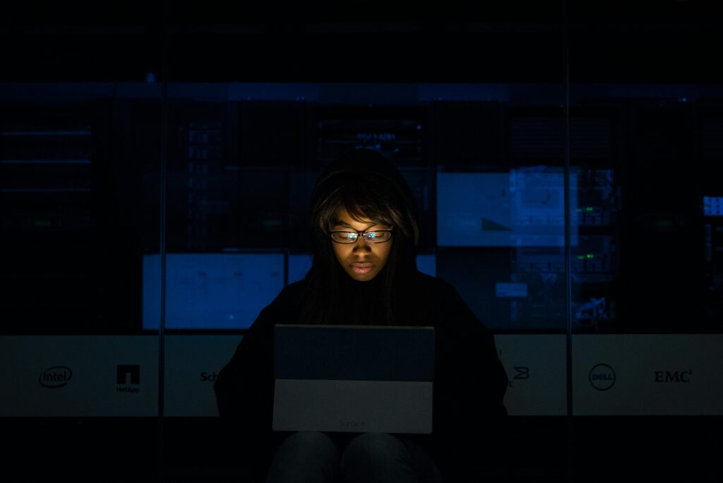 Photo by Christina Morillo: https://www.pexels.com/photo/woman-wearing-black-hoodie-jacket-holding-grey-laptop-computer-1181325/ IT