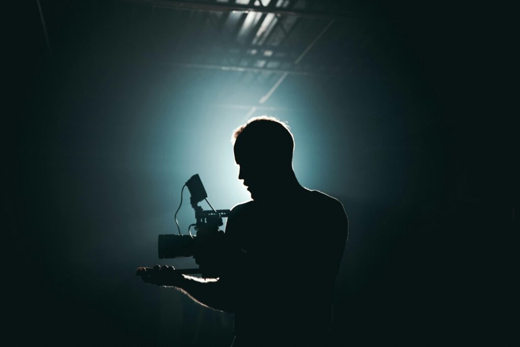 Photo by Kyle Loftus: https://www.pexels.com/photo/silhouette-of-man-standing-in-front-of-microphone-3379934/