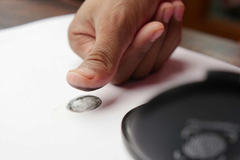 Photo by Towfiqu barbhuiya: https://www.pexels.com/photo/a-person-putting-a-fingerprint-on-a-white-paper-12375509/