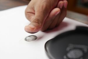 Photo by Towfiqu barbhuiya: https://www.pexels.com/photo/a-person-putting-a-fingerprint-on-a-white-paper-12375509/