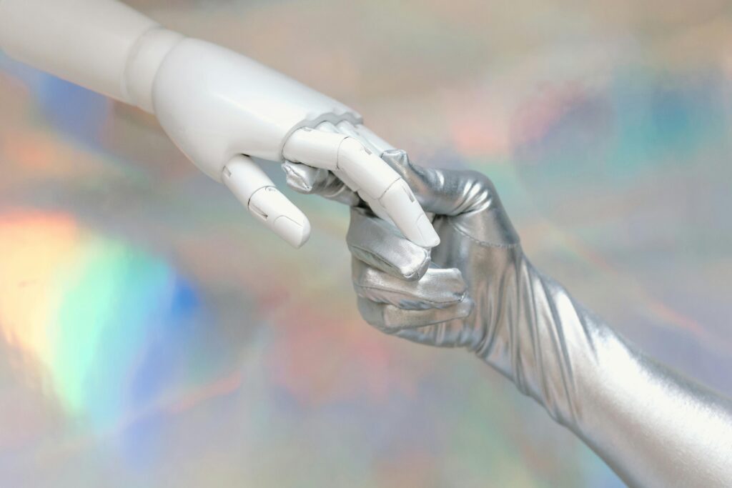 Photo by Tara Winstead: https://www.pexels.com/photo/hand-with-silver-glove-holding-a-robot-hand-8849283/
