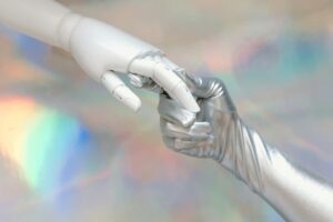 Photo by Tara Winstead: https://www.pexels.com/photo/hand-with-silver-glove-holding-a-robot-hand-8849283/