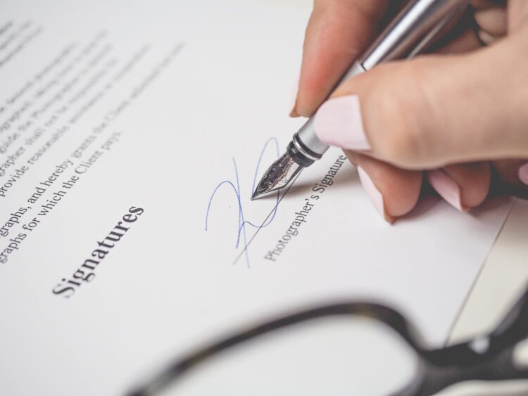 Photo by energepic.com: https://www.pexels.com/photo/person-holding-silver-pen-signing-photographers-signature-175045/