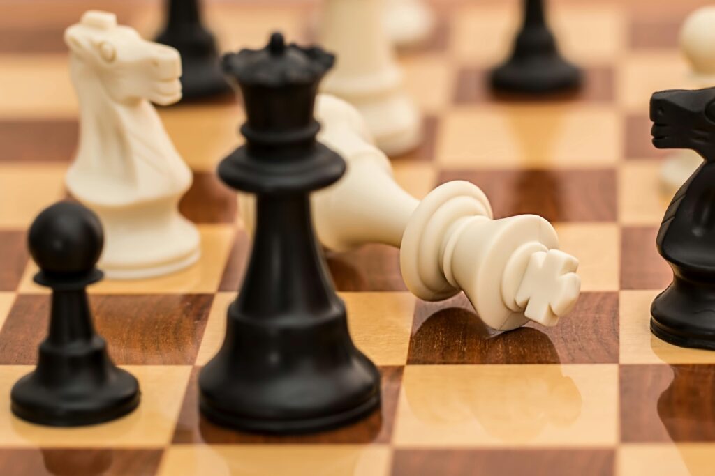 Photo by Pixabay: https://www.pexels.com/photo/black-white-and-brown-chess-board-game-139392/