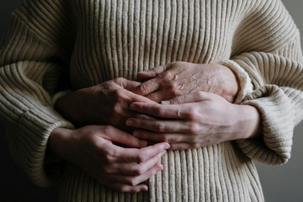 Photo by cottonbro studio: https://www.pexels.com/photo/a-person-hugging-another-person-wearing-knitted-sweater-5493794/