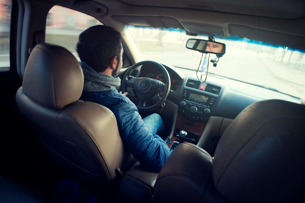 Photo by Atlantic Ambience: https://www.pexels.com/photo/man-wearing-blue-jacket-sitting-inside-car-while-driving-376729/
